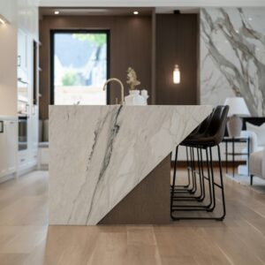 Modern kitchen with a large marble island and bar stools