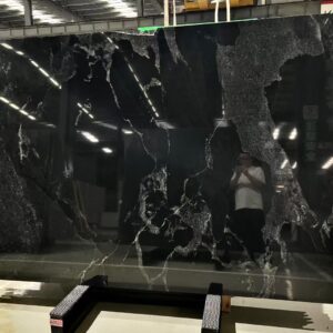 Black River granite slab with a black background and pale mineral lines