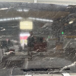 Dark Brazilian black granite slab with pale flowing mineral markings