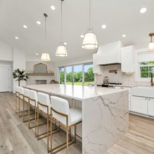 Large kitchen with a marble island and white cabinets — photo by Zac Gudakov on Unsplash