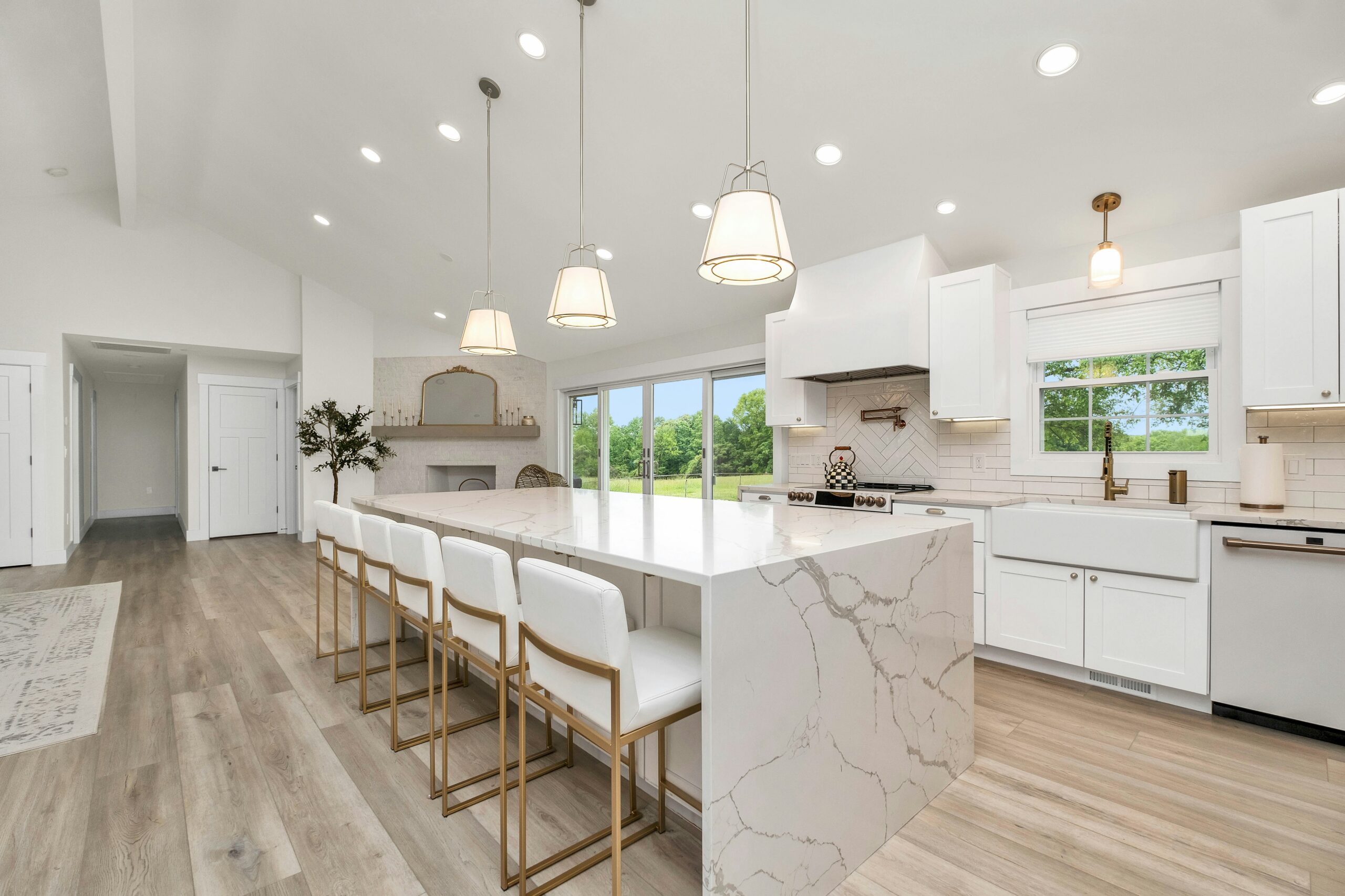 Large kitchen with a marble island and white cabinets — photo by Zac Gudakov on Unsplash